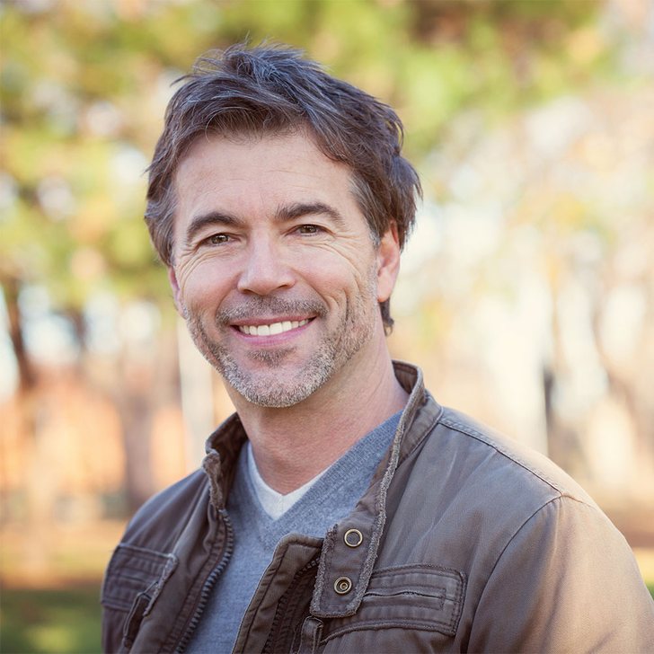 Smiling man &mdash; erectile dysfunction therapy at Evolved Medical
