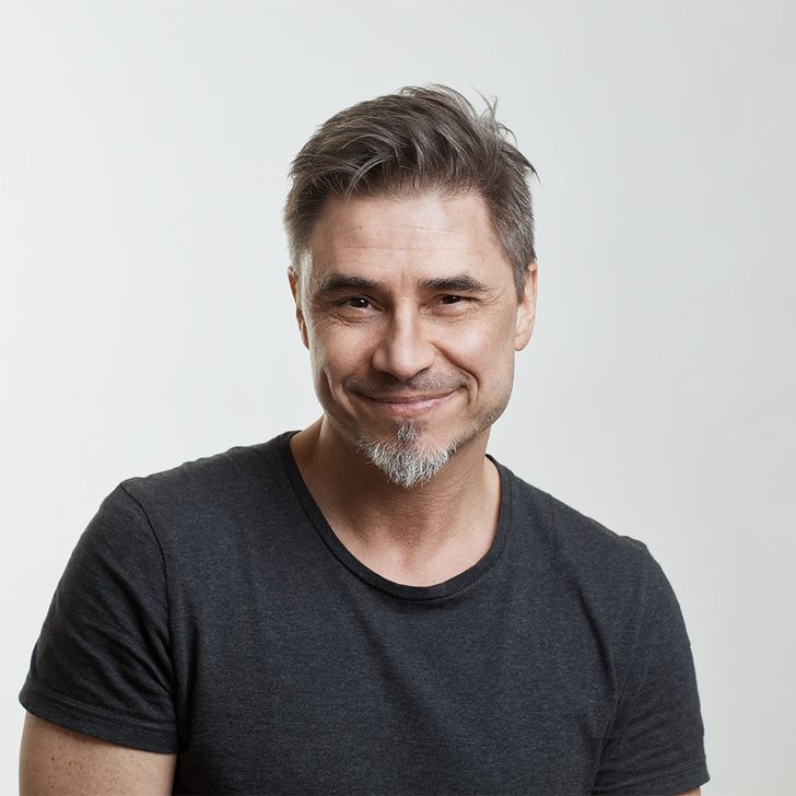 Smiling man &mdash; hormone replacement therapy for men at Evolved Medical