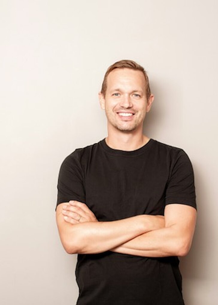 Smiling man with arms crossed &mdash; hormone replacement therapy for men at Evolved Medical